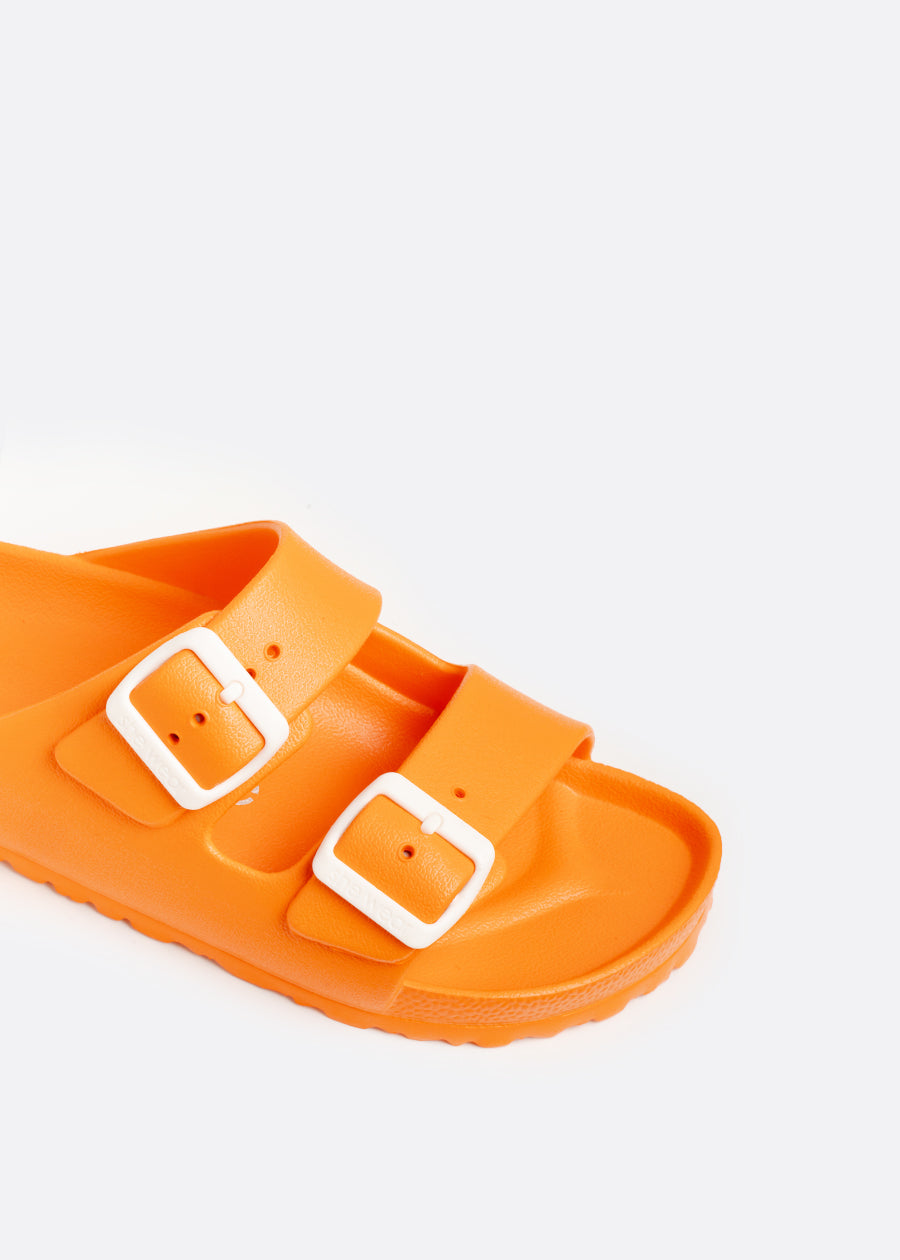 white buckles on the adjustable straps of a bright orange slide