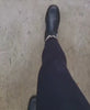 walking in black leather boots 