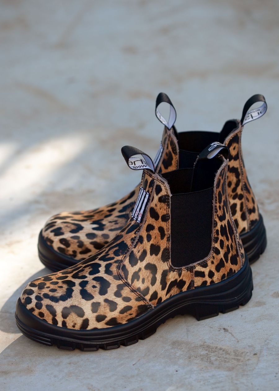 Pull-on safety boots with easy-pull tabs, black elastic sides, and leather printed with a leopard pattern